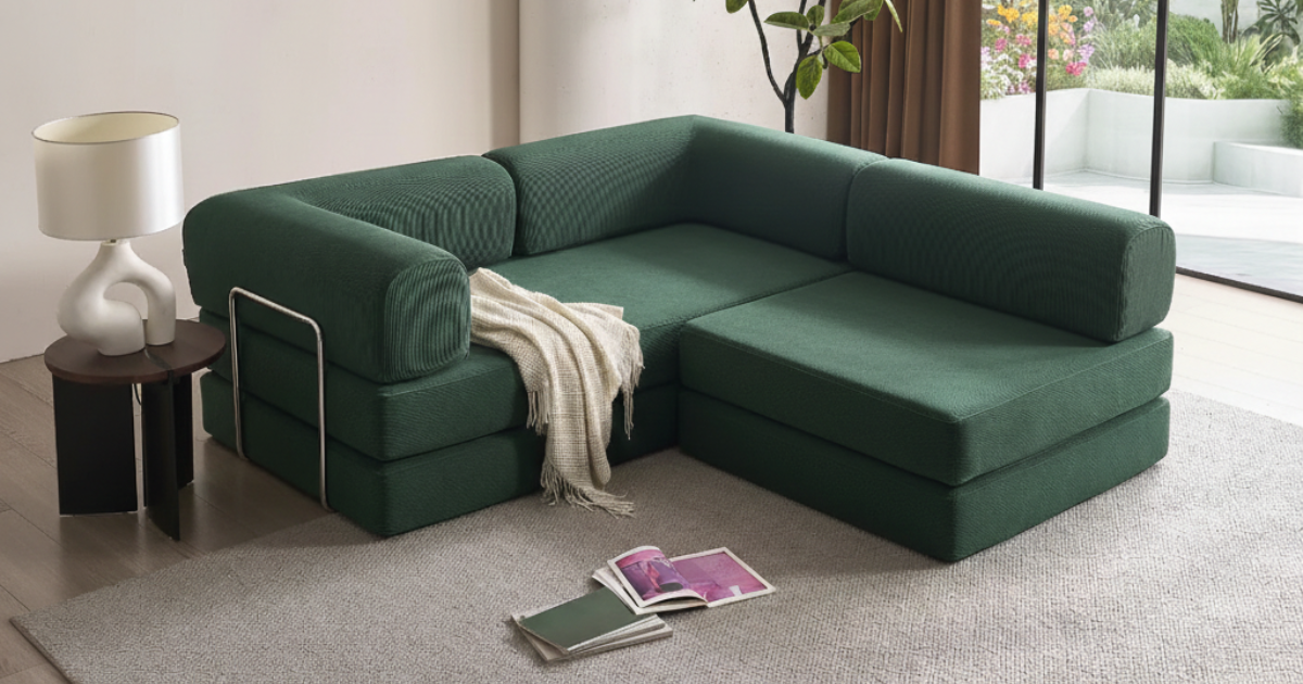 Forest green L shaped compressed sofabed on a grey rug and with a black side table and a curved lamp | Bubuland Home Australia