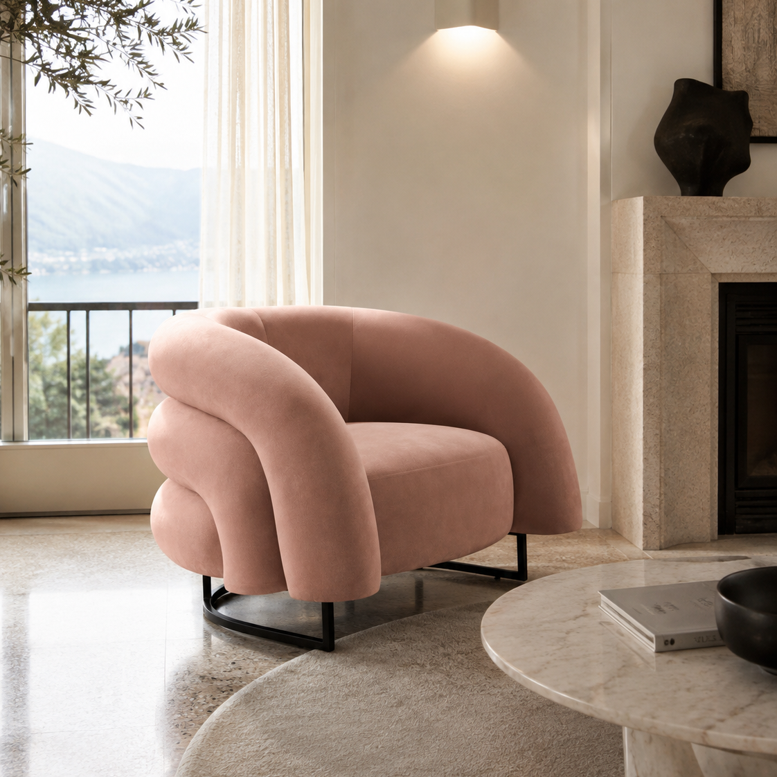 A blush pink velvet accent chair with a curved, sculptural backrest and black metal legs, positioned in a modern living room next to a marble fireplace and a large window with an outdoor view.