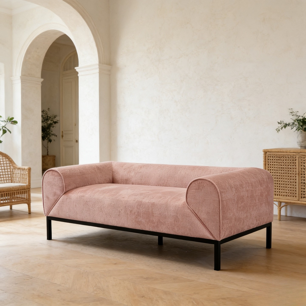 Pink sofa in a room with white walls and wooden floors