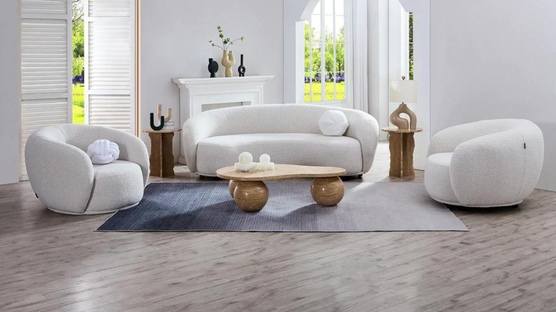 Curvo Sofa and armchairs with Travertine Sphere Coffee table in living room setting