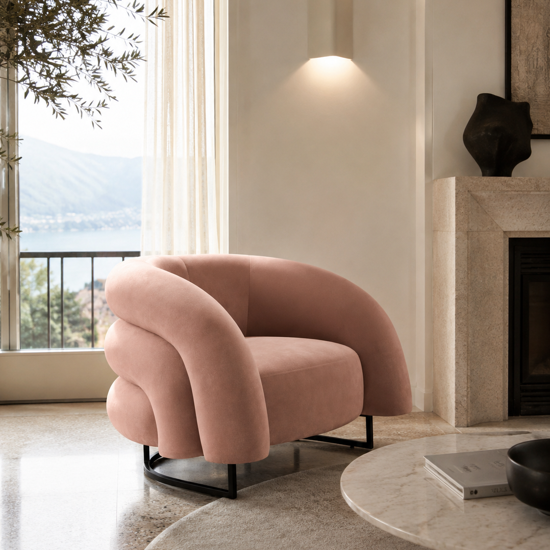 A blush pink velvet accent chair with a curved, sculptural backrest and black metal legs, positioned in a modern living room next to a marble fireplace and a large window with an outdoor view.