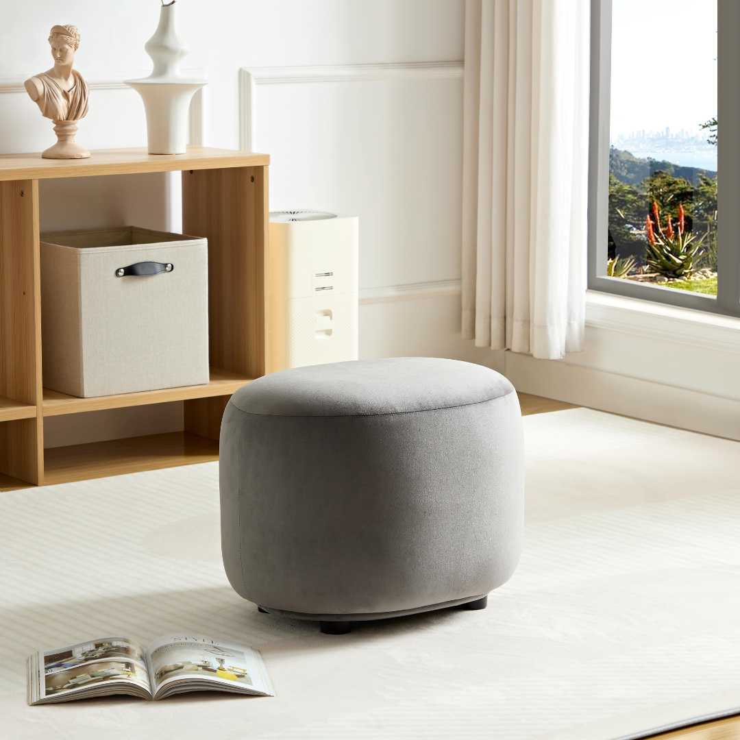 Curvo Velvet Oval Ottoman - Grey on Side   View in Room Setting