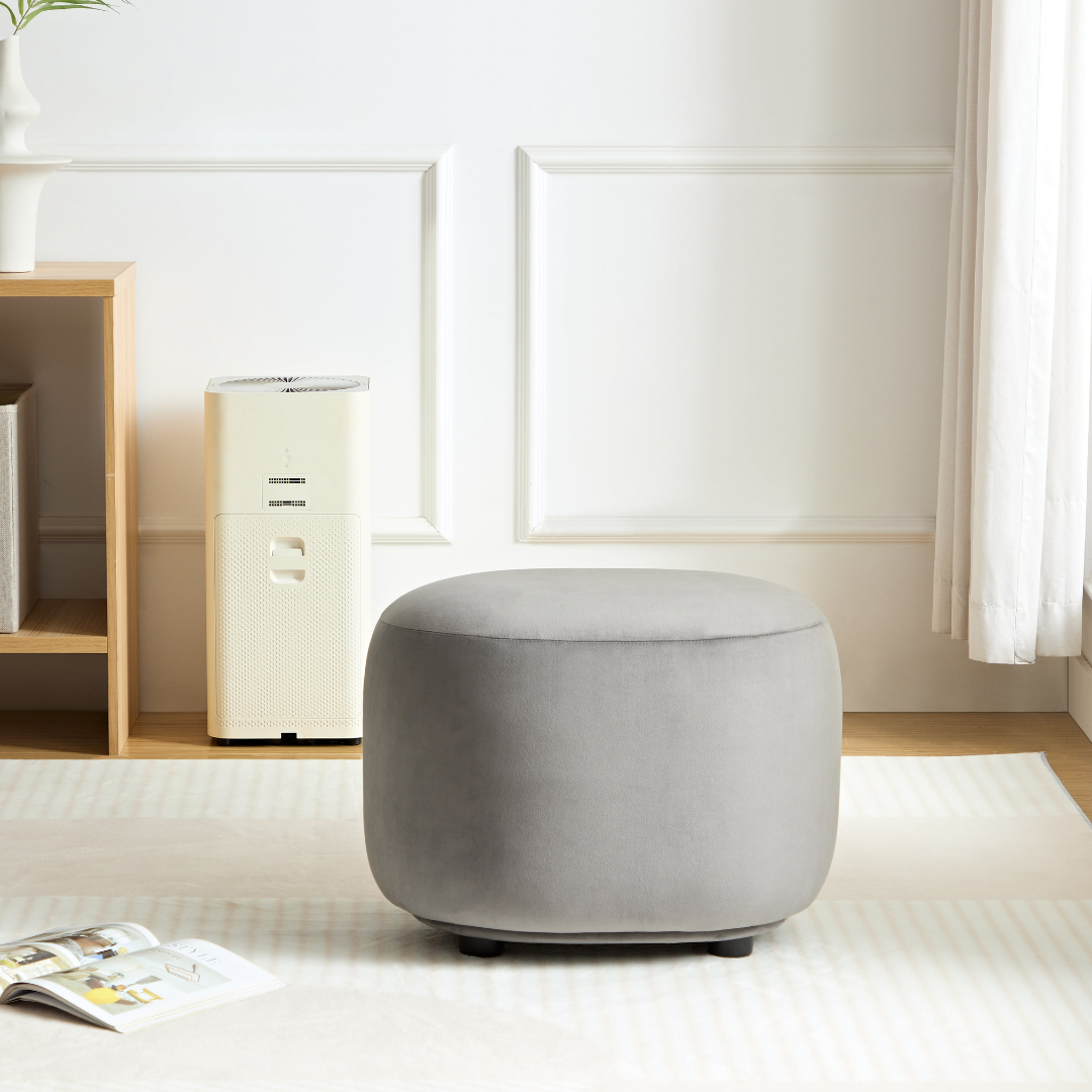 Curvo Velvet Oval Ottoman - Grey on Side View in Room Setting