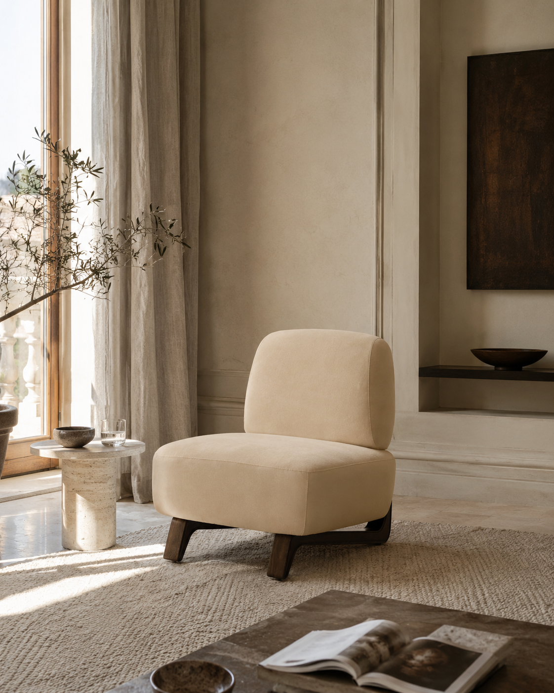 A cream-colored upholstered accent chair with dark wooden legs, positioned in a bright, modern, minimalist living room with warm neutral tones.