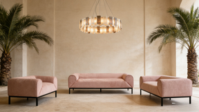 Modern living room with pink sofa set and decorative chandelier.