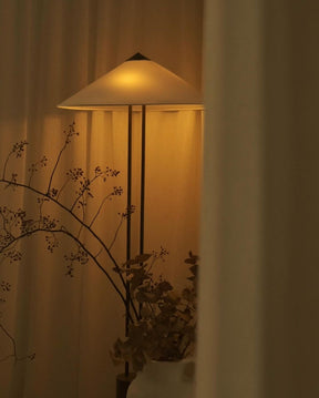 Decorative wall lamp with a warm glow in a softly lit room.